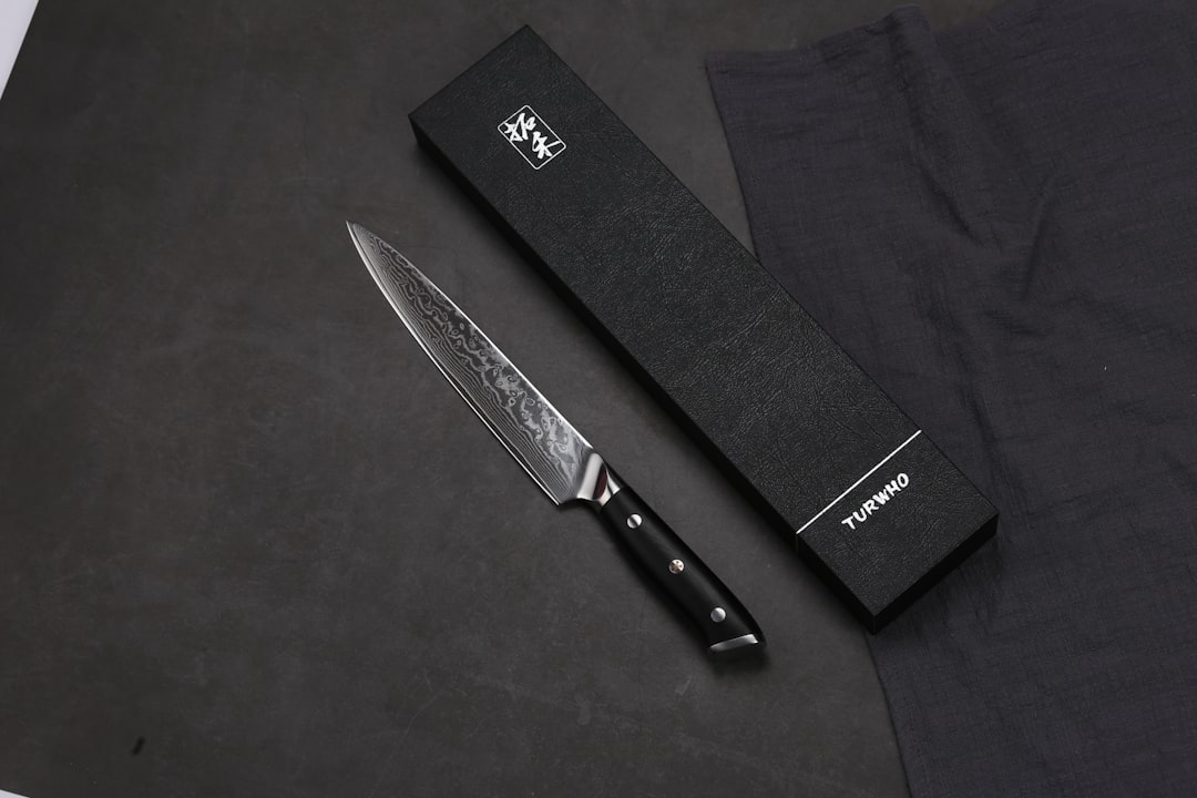 A sharp damascus chef's knife with its box